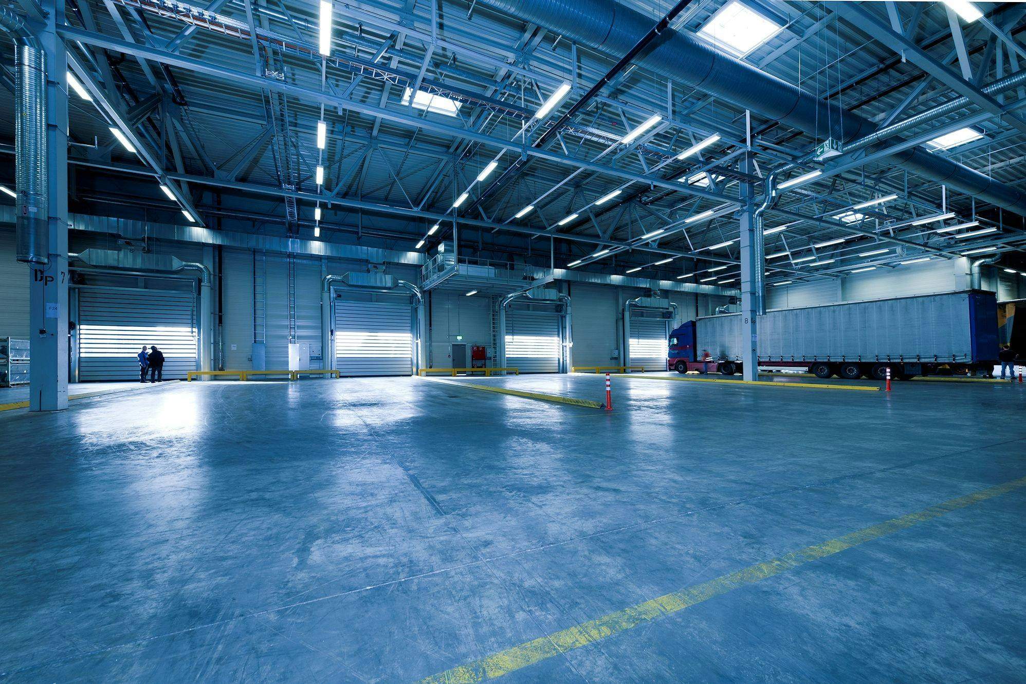 Spacious warehouse interior with loading doors and truck